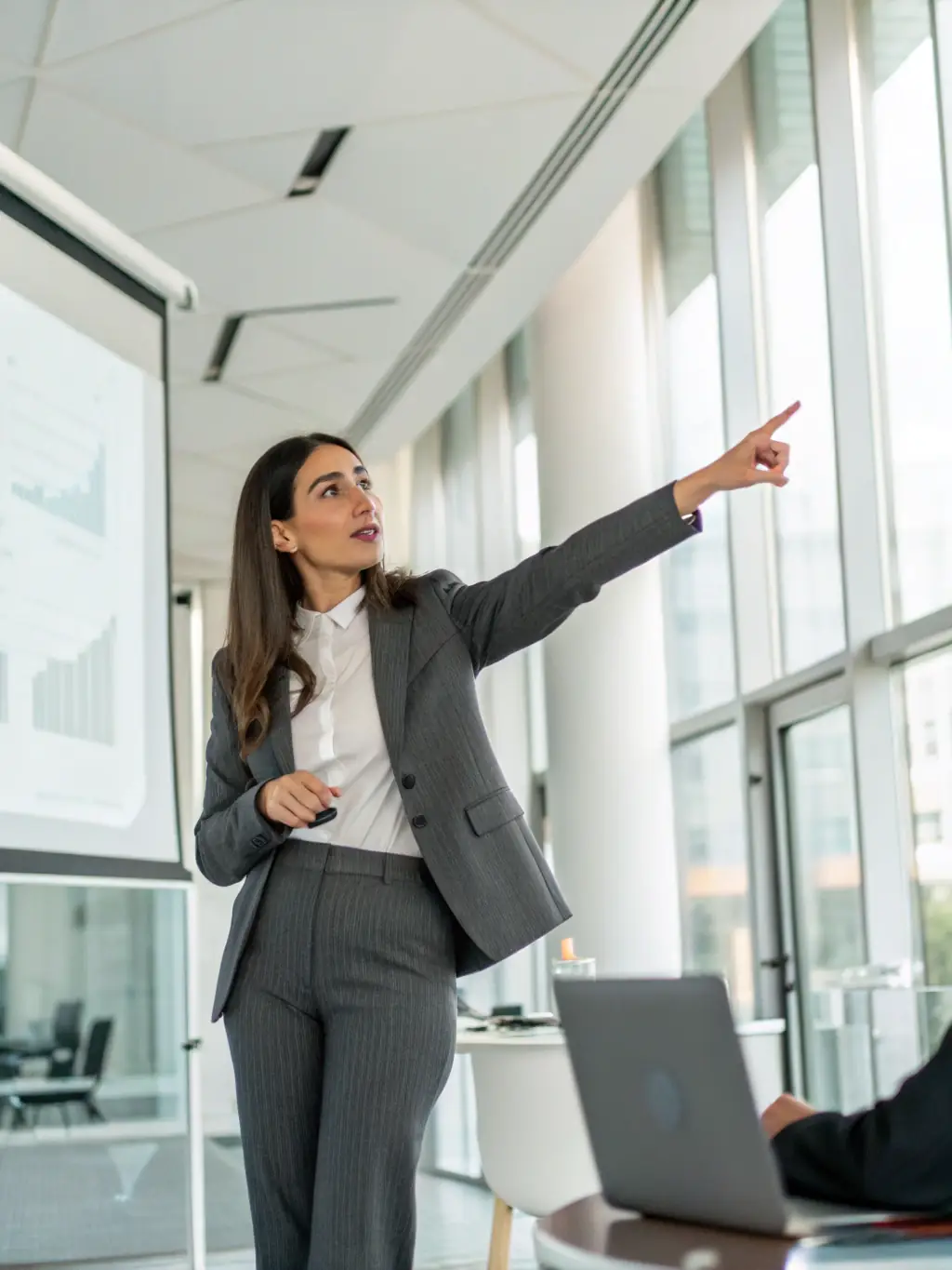 A person confidently presenting to a group, representing public speaking and communication skills.