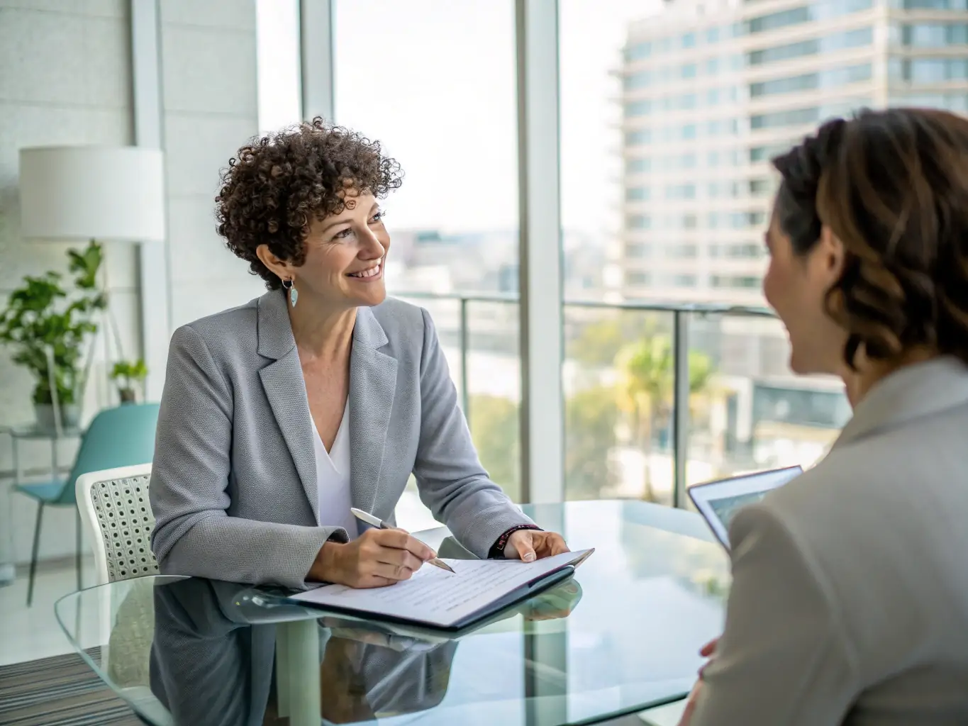 A professional coach guiding a client through a personal growth exercise in a modern office setting, emphasizing the one-on-one support and tailored approach.